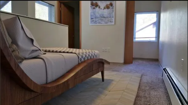 a bedroom with a bed and a window