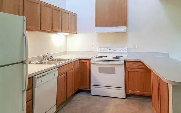 a kitchen with granite countertop cabinets stainless steel appliances and sink