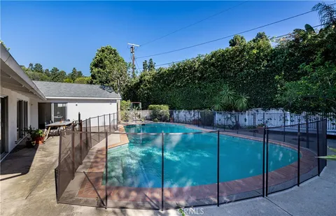 a swimming pool with outdoor seating and yard