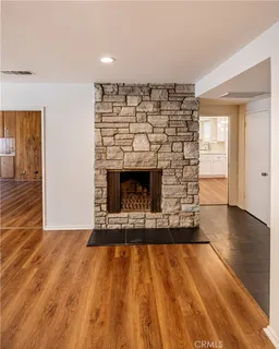 a view of an empty room and wooden floor