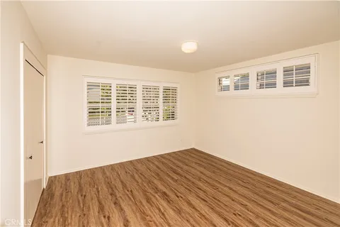 an empty room with wooden floor