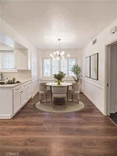 a kitchen with granite countertop a stove and white cabinets