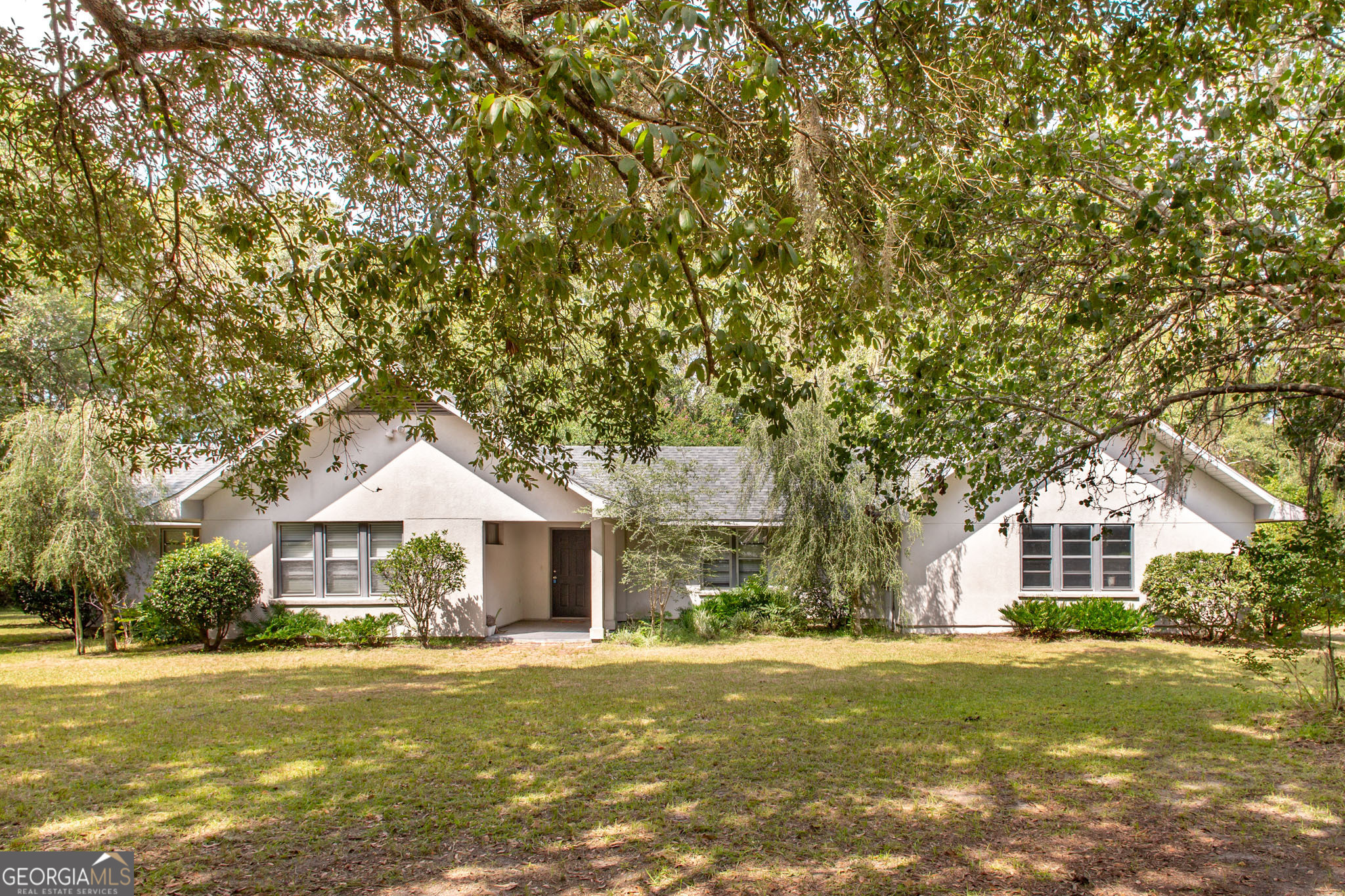 a front view of a house with a garden and porch