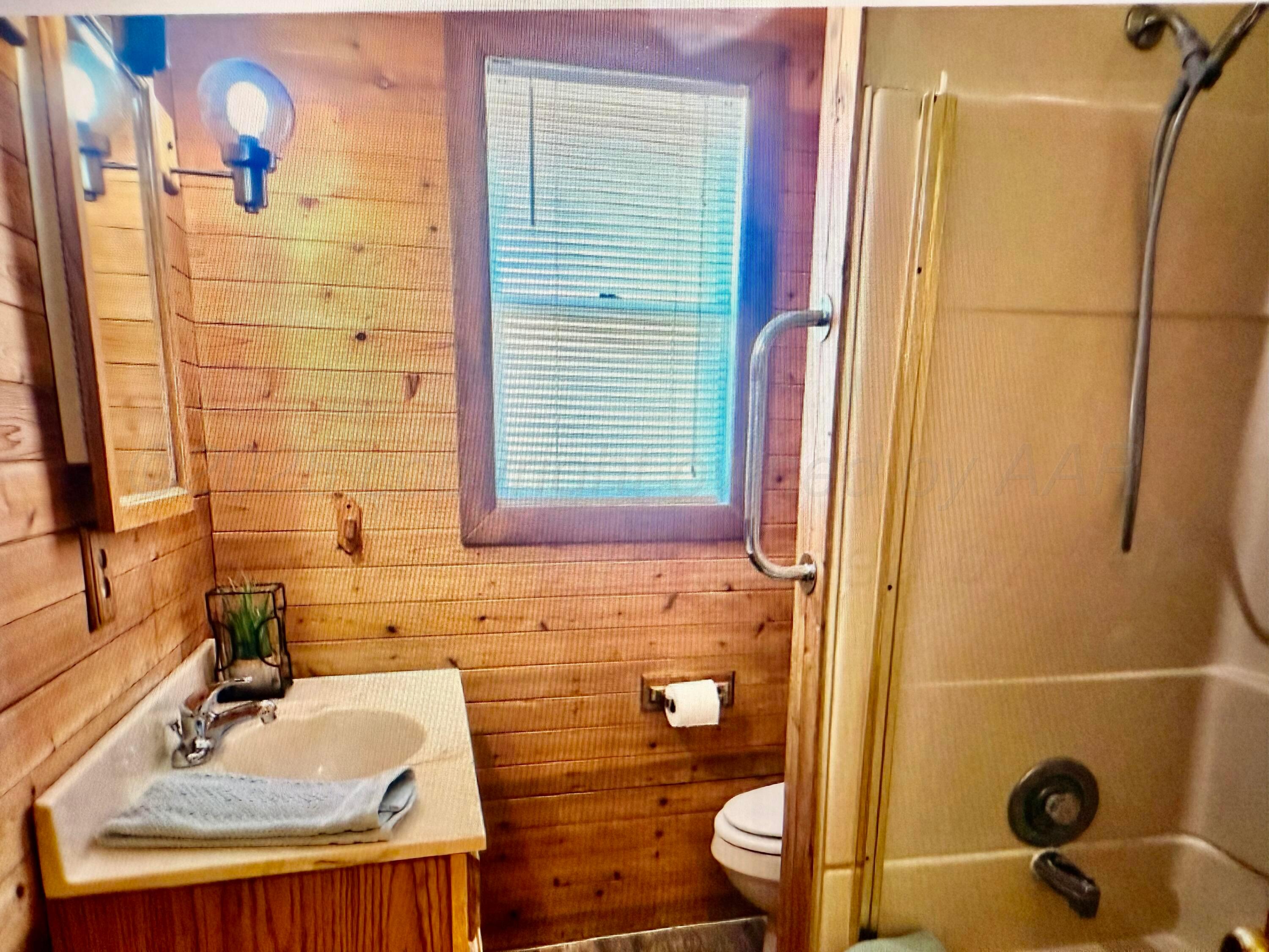 4612 South Lamar Street Amarillo, TX 79110 - Photo 6 of 8 a bathroom with a sink and a mirror