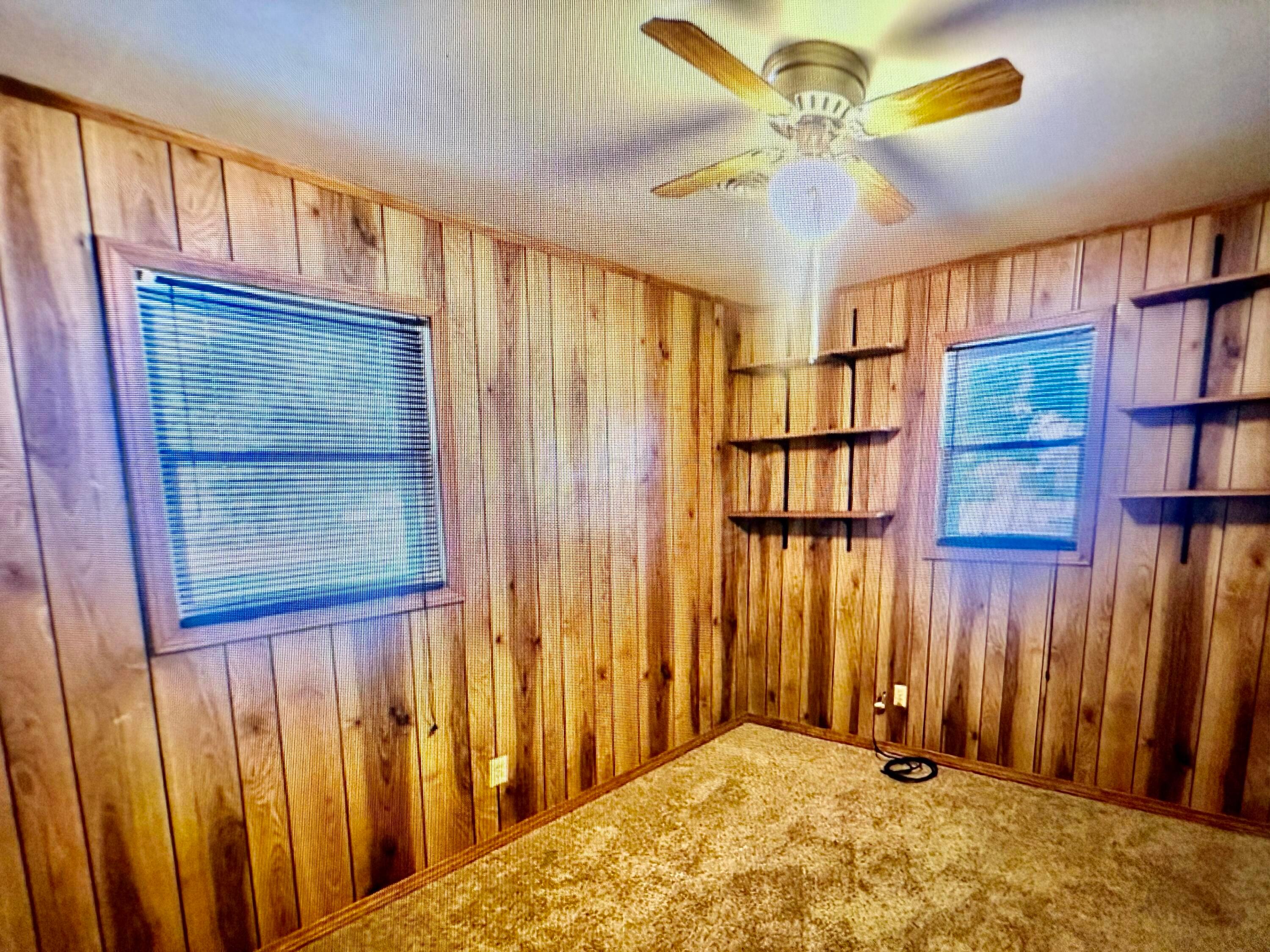 4612 South Lamar Street Amarillo, TX 79110 - Photo 7 of 8 a bedroom with a bed and a chandelier