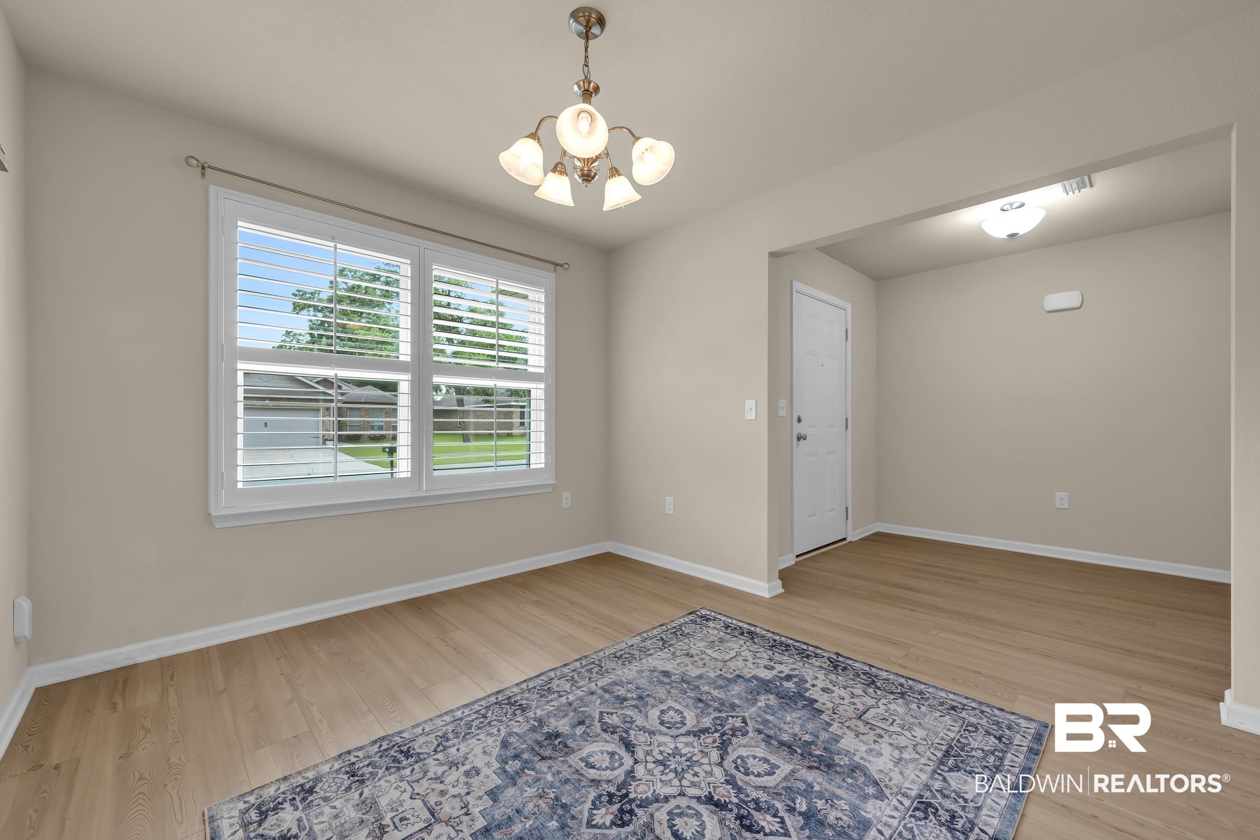 1704 Abbey Loop Foley, AL 36535 - Photo 7 of 38 Bright interior space featuring light wood-finish flooring, neutral wall tones, and crown molding