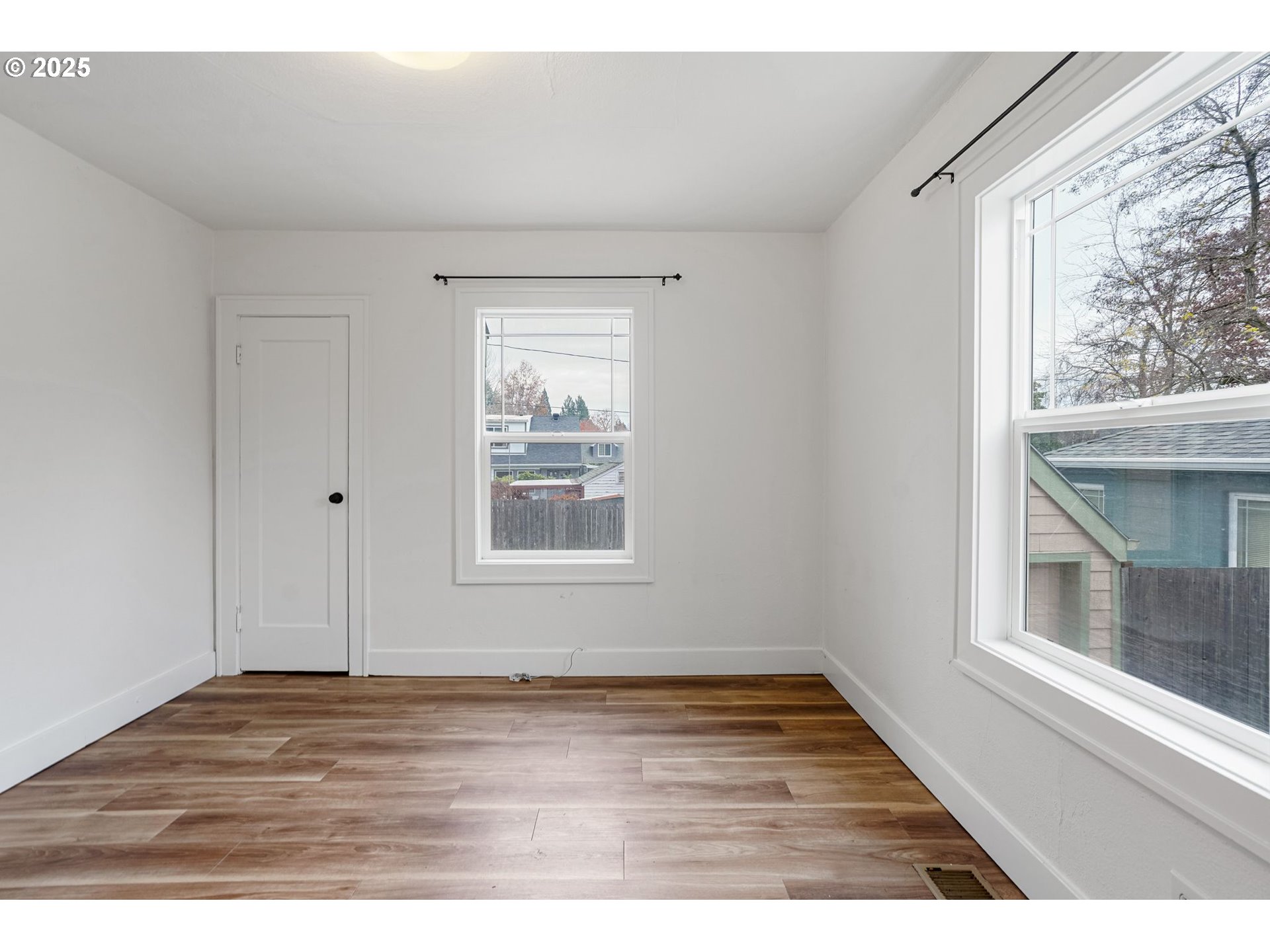 562 21st Street Northeast Salem, OR 97301 - Photo 16 of 45 an empty room with wooden floor and windows