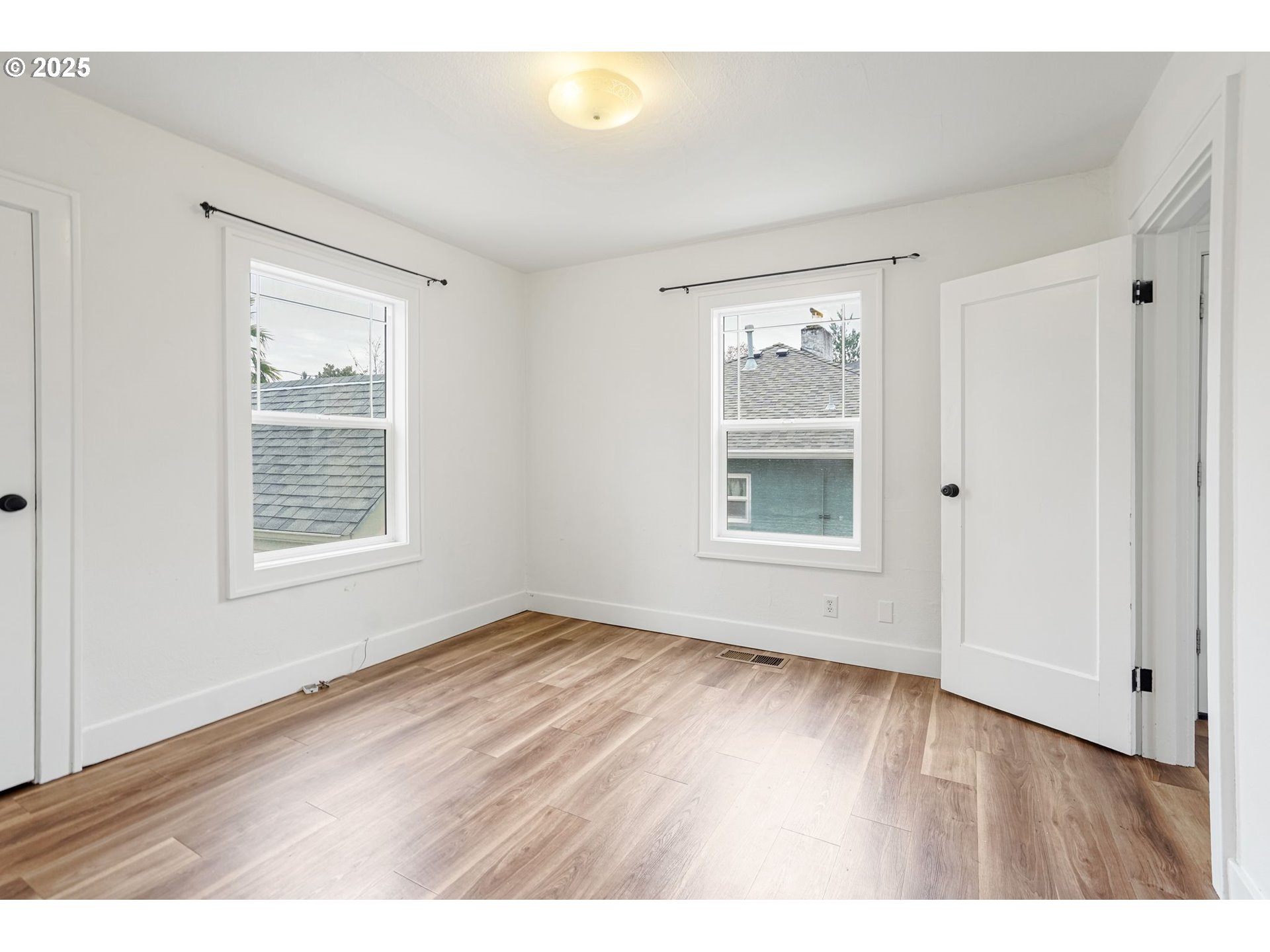 562 21st Street Northeast Salem, OR 97301 - Photo 18 of 45 a view of an empty room with wooden floor and a window
