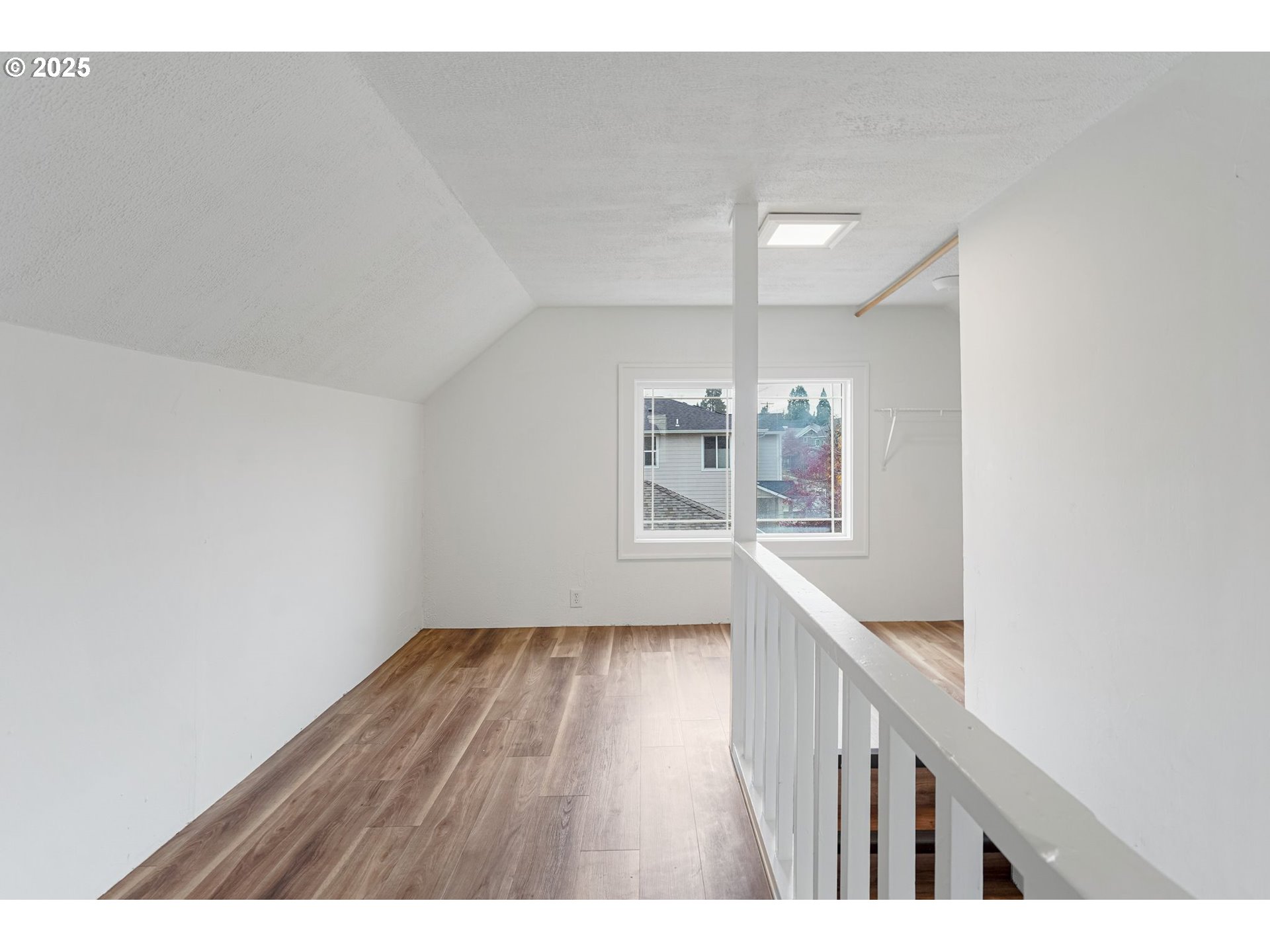 562 21st Street Northeast Salem, OR 97301 - Photo 27 of 45 a view of an empty room with wooden floor and a window