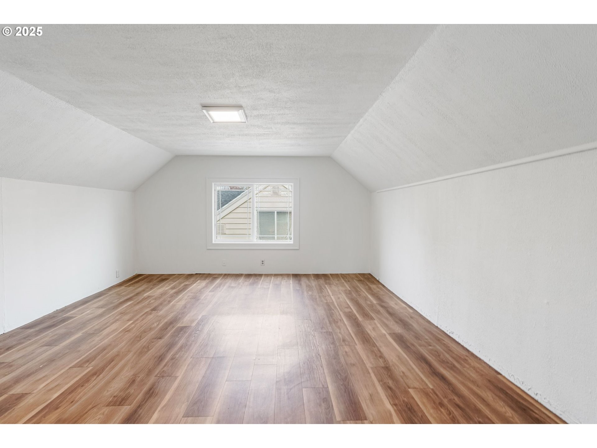 562 21st Street Northeast Salem, OR 97301 - Photo 28 of 45 a view of an empty room with wooden floor and a window