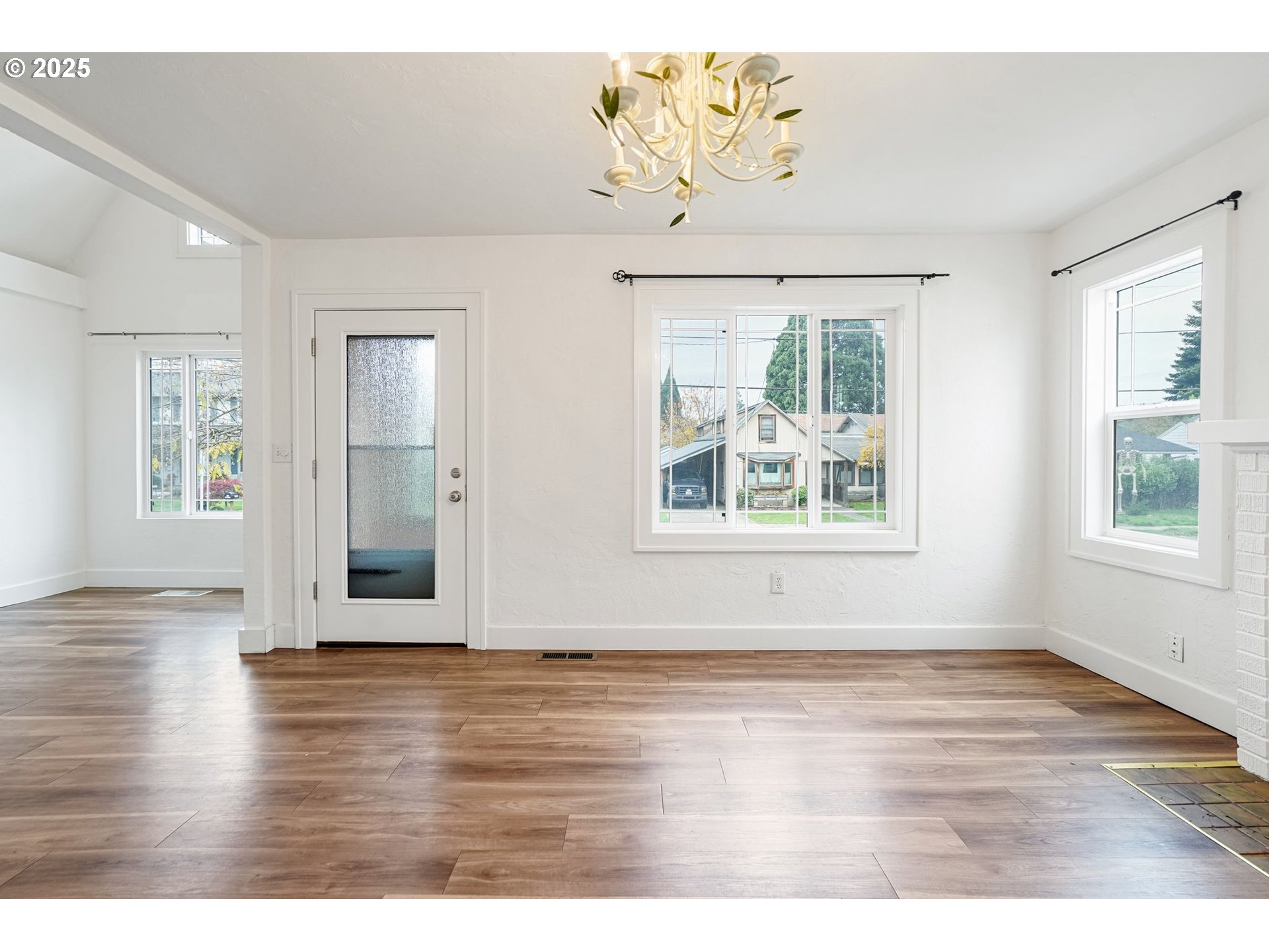 562 21st Street Northeast Salem, OR 97301 - Photo 7 of 45 an empty room with wooden floor chandelier and windows