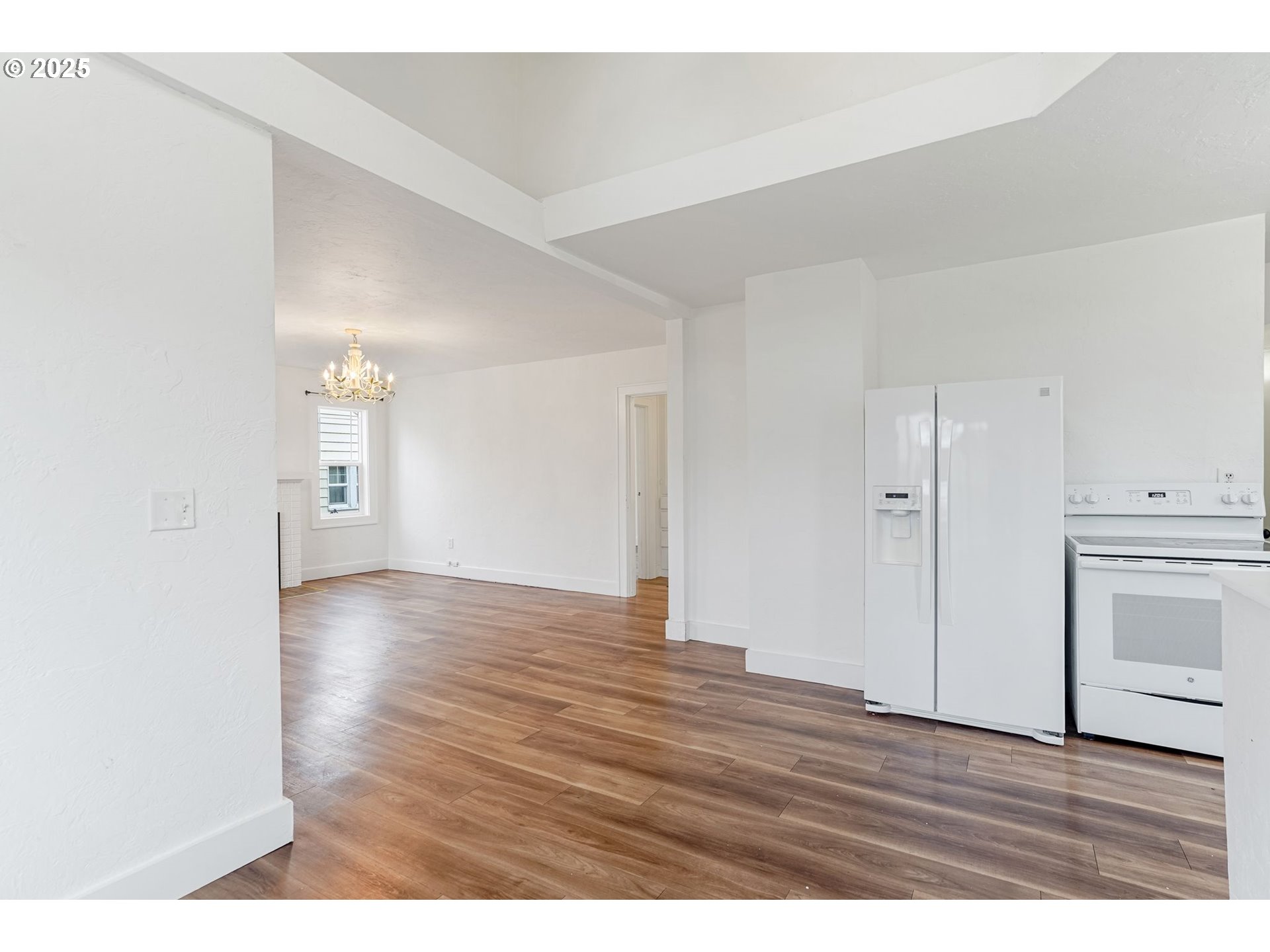 562 21st Street Northeast Salem, OR 97301 - Photo 10 of 45 a view of an empty room with wooden floor and cabinets