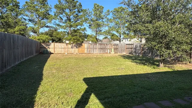 a garden view with a fountain in the background