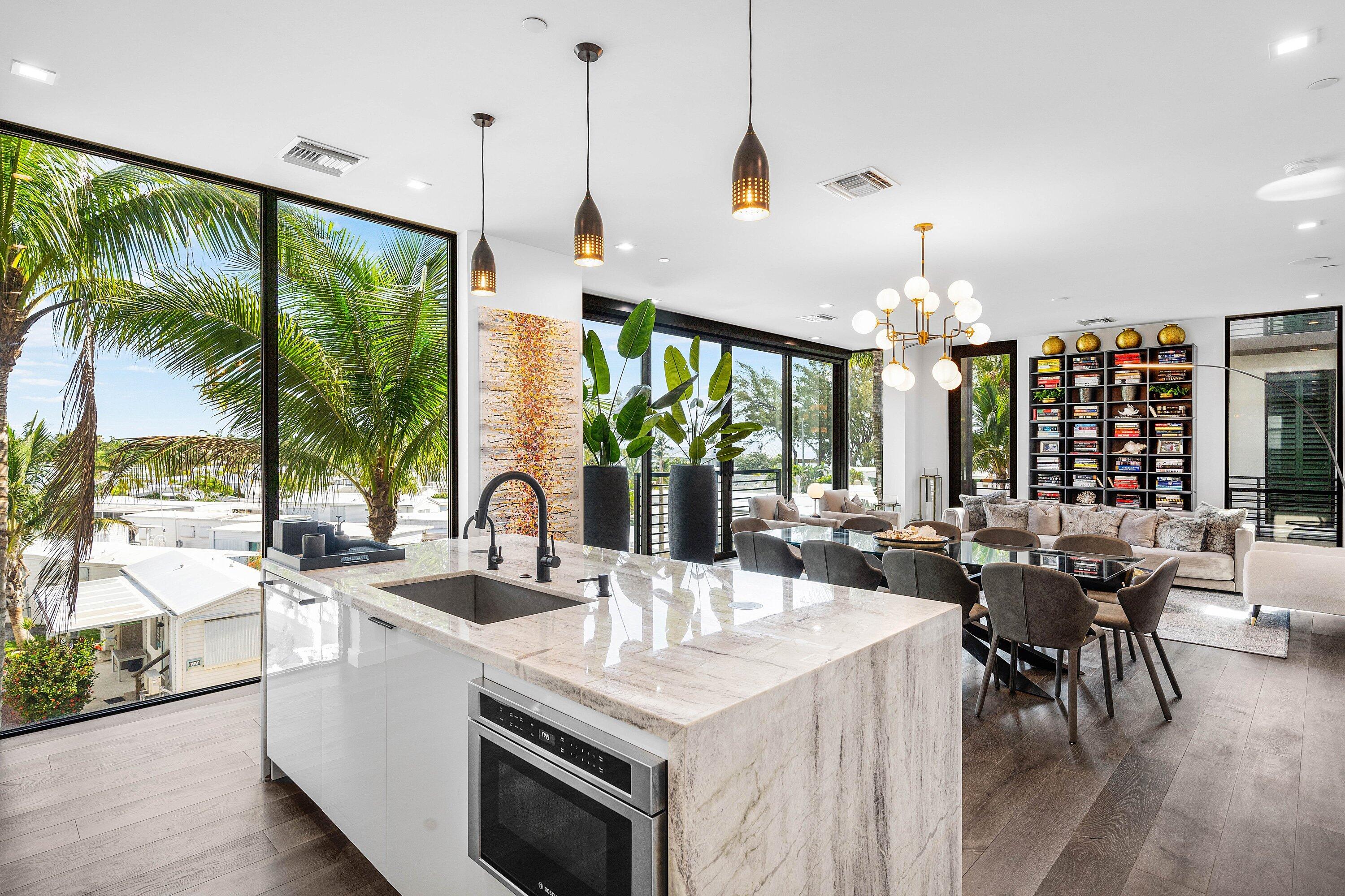 11501 Old Ocean Boulevard Ocean Ridge, FL 33435 - Photo 32 of 70 a kitchen with stainless steel appliances granite countertop a stove and a view of living room