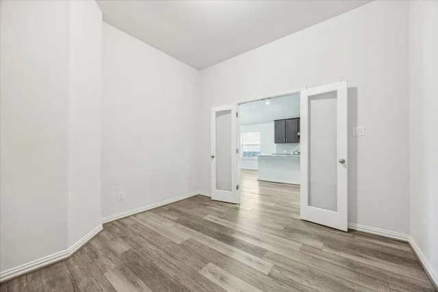 a large kitchen with stainless steel appliances a large counter top a stove and a refrigerator