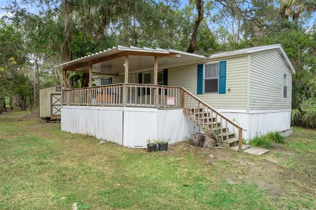 a view of a house with a yard and sitting area