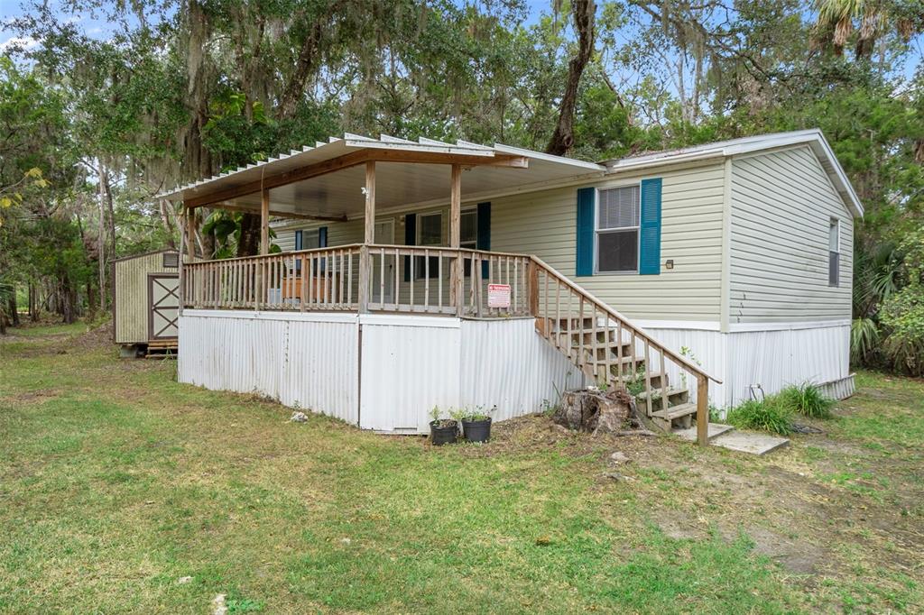a view of a house with a yard and sitting area