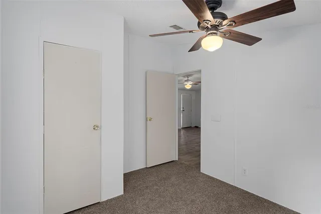 a view of a porch with wooden floor and furniture