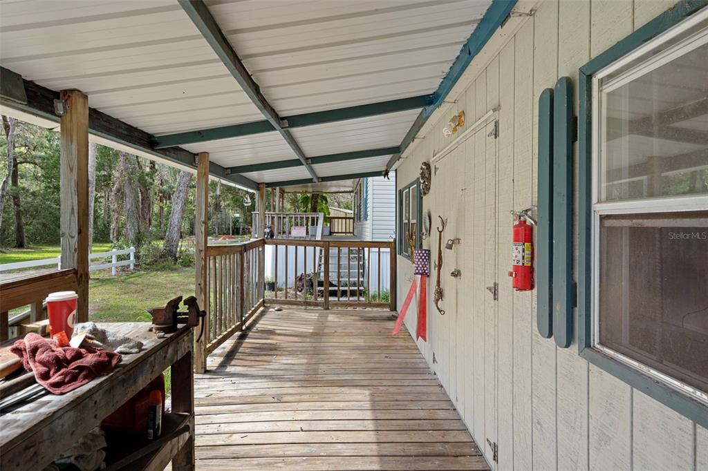 6176 South Hancock Road Homosassa, FL 34448 - Photo 17 of 33 a view of a porch with wooden floor and furniture