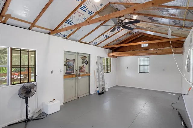 an aerial view of residential houses with outdoor space and trees