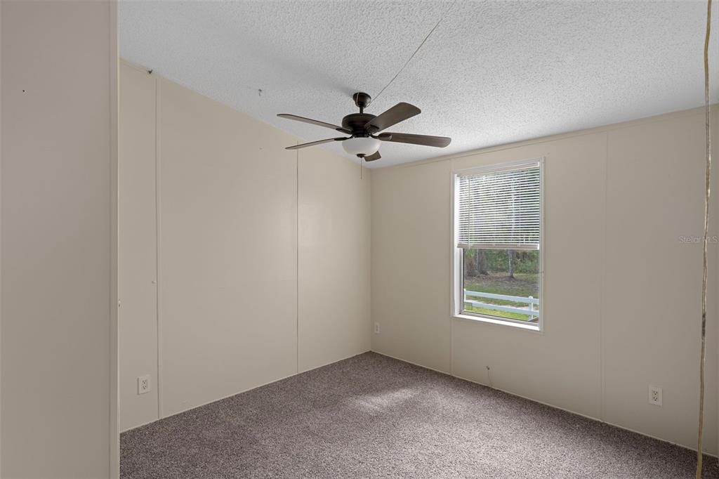 6176 South Hancock Road Homosassa, FL 34448 - Photo 10 of 33 an empty room with windows and fan