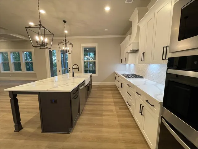 a kitchen with kitchen island a sink and wooden floor