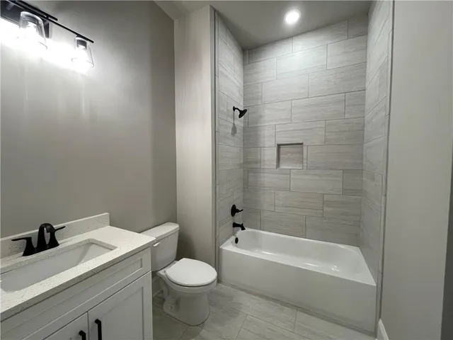 a bathroom with a sink a toilet and bathtub