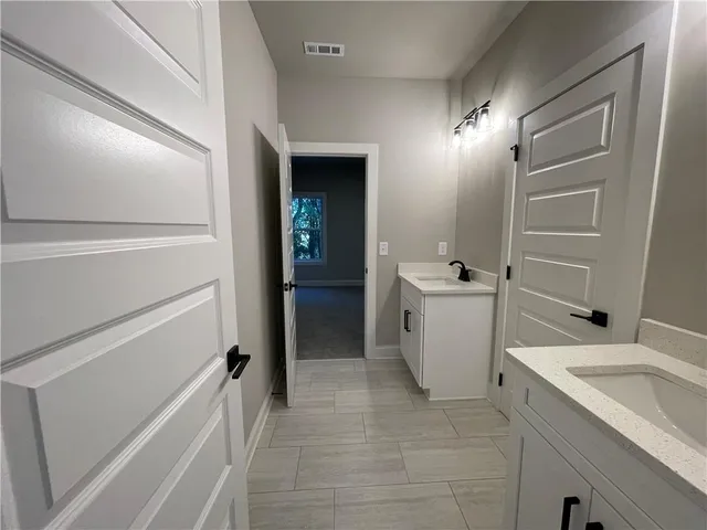 a bathroom with a sink a toilet and vanity