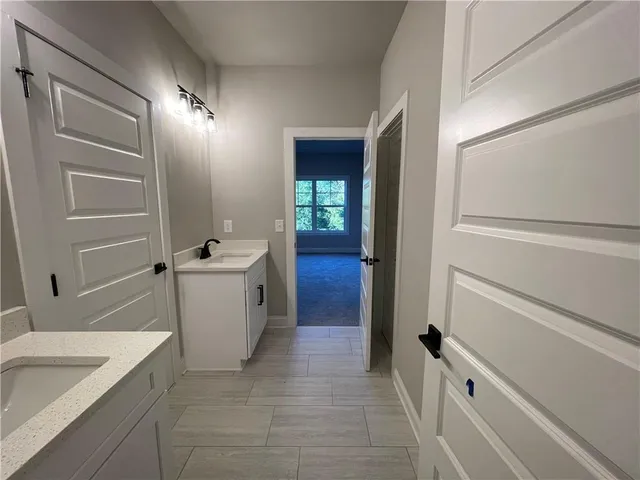 a bathroom with a granite countertop sink a toilet and bathtub