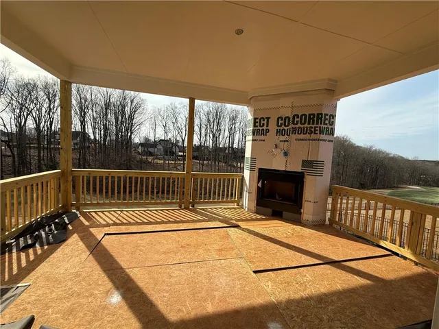 a view of balcony with a floor to ceiling window and potted plants