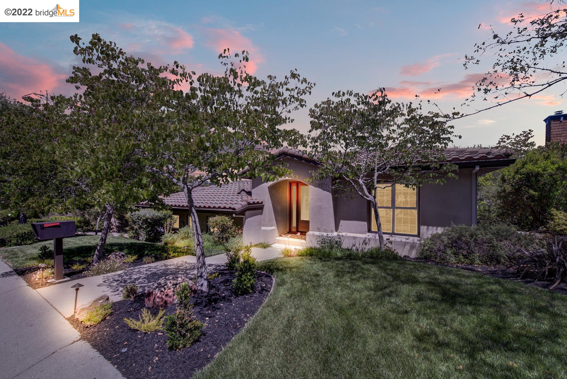 77 Oak Road Orinda, CA 94563 - Photo 1 of 1 a front view of a house with a yard and a large tree