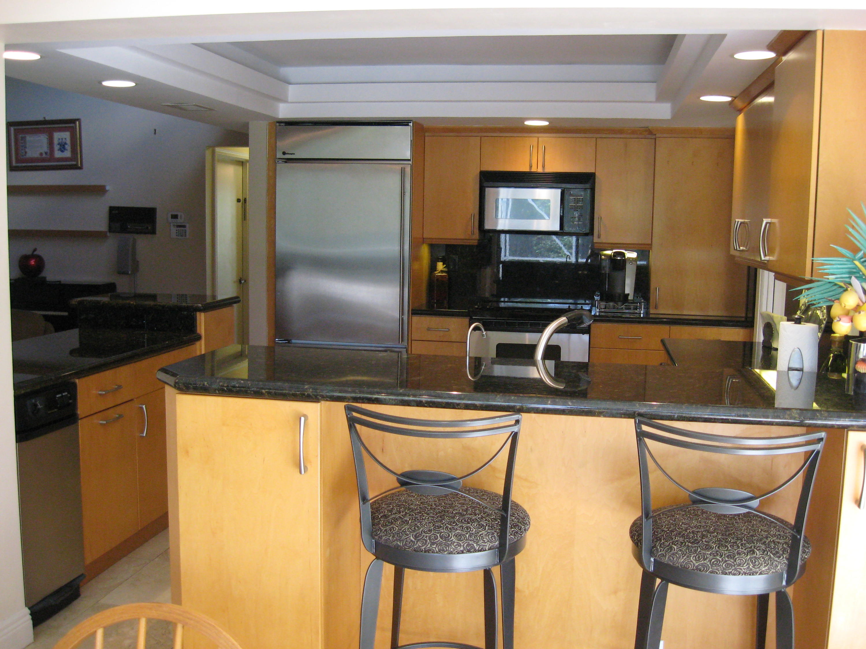 780 Southwest 17th Street Boca Raton, FL 33486 - Photo 6 of 37 a kitchen with stainless steel appliances granite countertop a sink a stove and a refrigerator