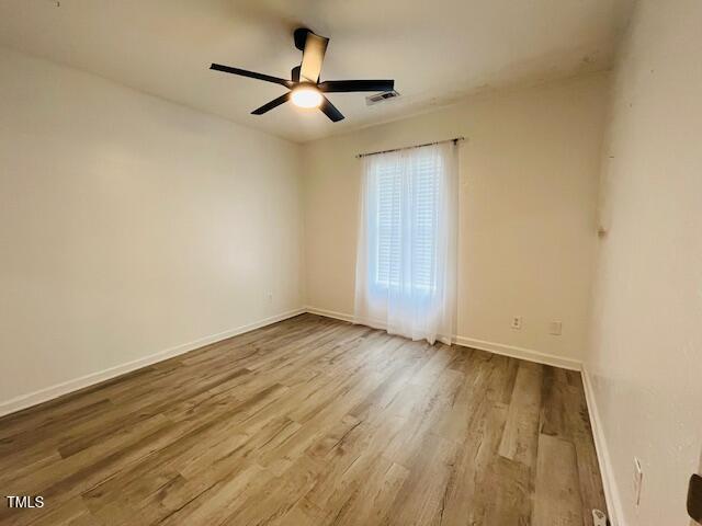 830 Northview Drive Sanford, NC 27332 - Photo 13 of 20 an empty room with wooden floor and a ceiling fan
