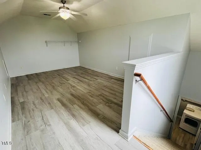 a view of a room with wooden floor and white walls