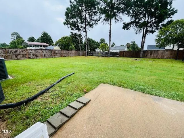 a view of backyard with swimming pool