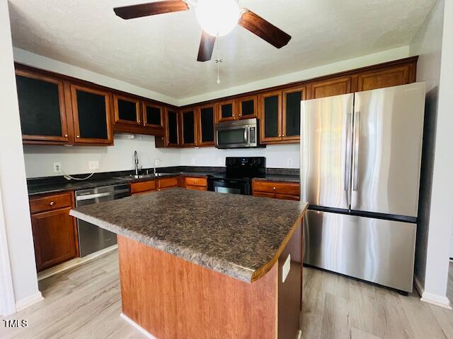 830 Northview Drive Sanford, NC 27332 - Photo 6 of 20 a kitchen with stainless steel appliances granite countertop a refrigerator a stove and a sink with wooden floor