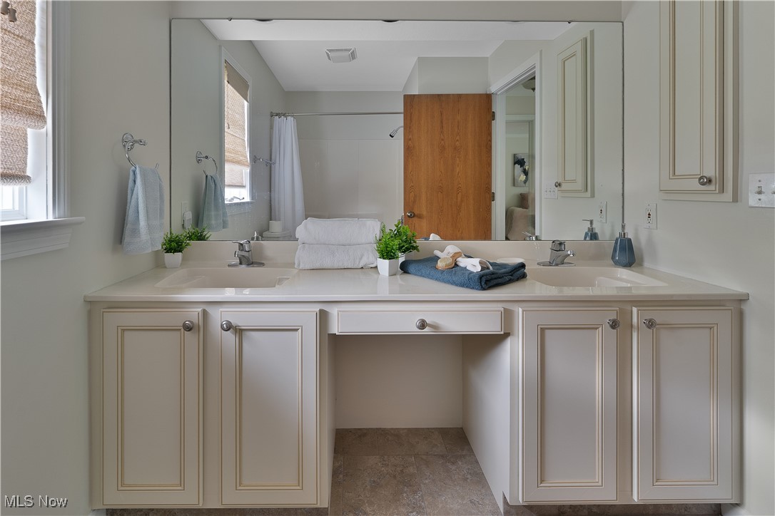 7091 South Raccoon Road Canfield, OH 44406 - Photo 36 of 39 Bathroom featuring double vanity and curtained shower