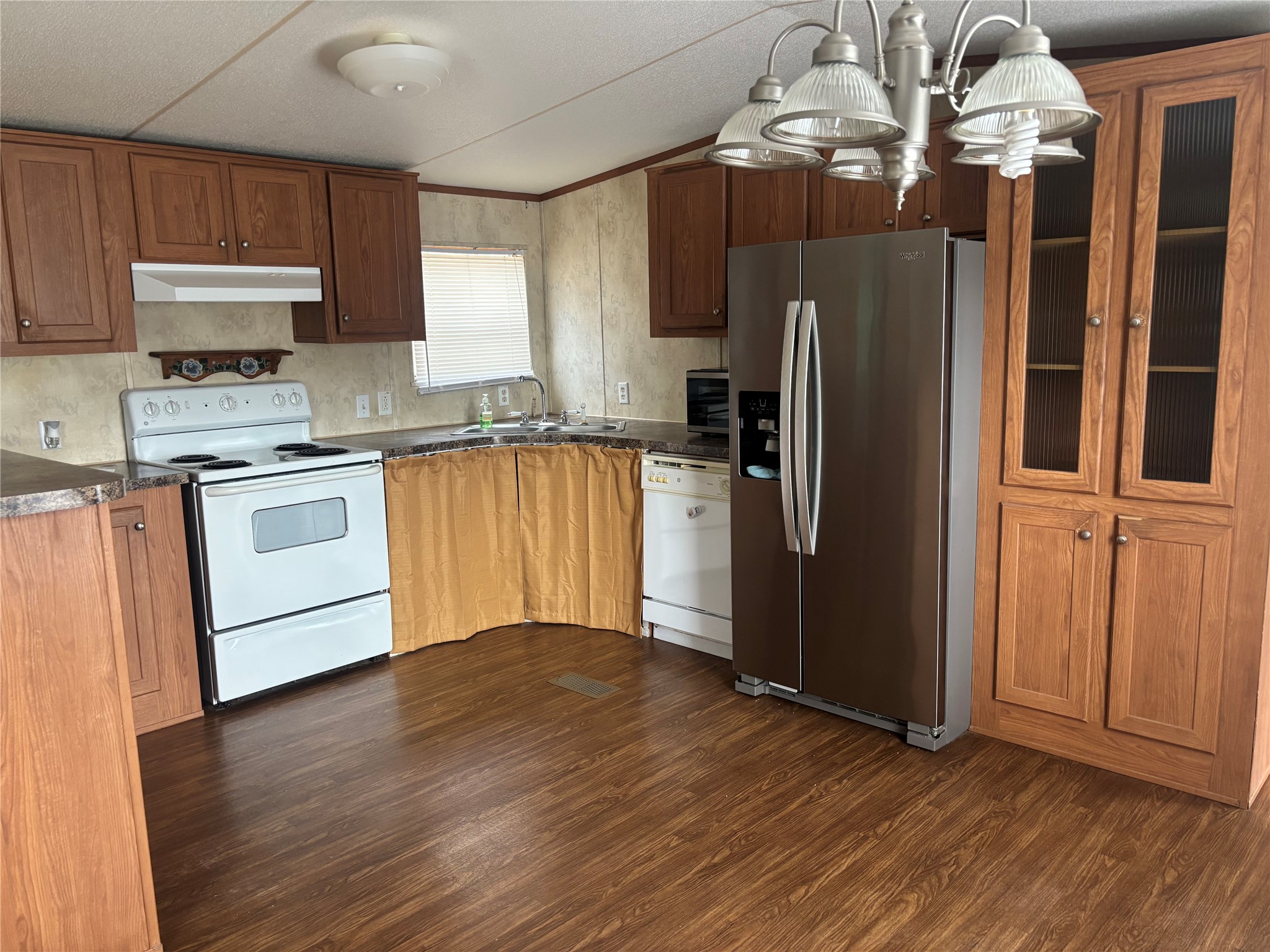 151 Cottle Town Road Smithville, TX 78957 - Photo 11 of 22 a kitchen with granite countertop wooden floors stainless steel appliances and a counter space