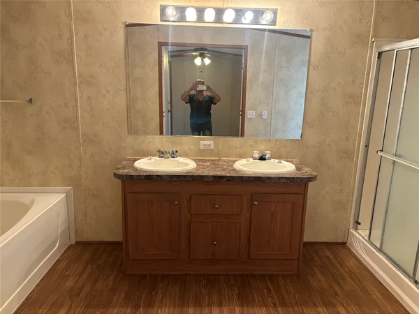 a view of a bathroom with a sink and a mirror