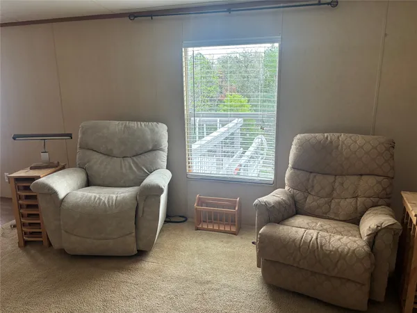 a view of a livingroom with furniture and windows