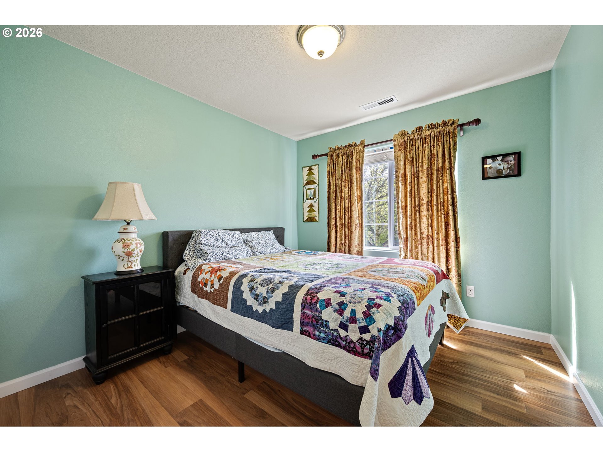 265 Southeast Casting Street Albany, OR 97322 - Photo 25 of 48 a bedroom with a bed window and a night stand