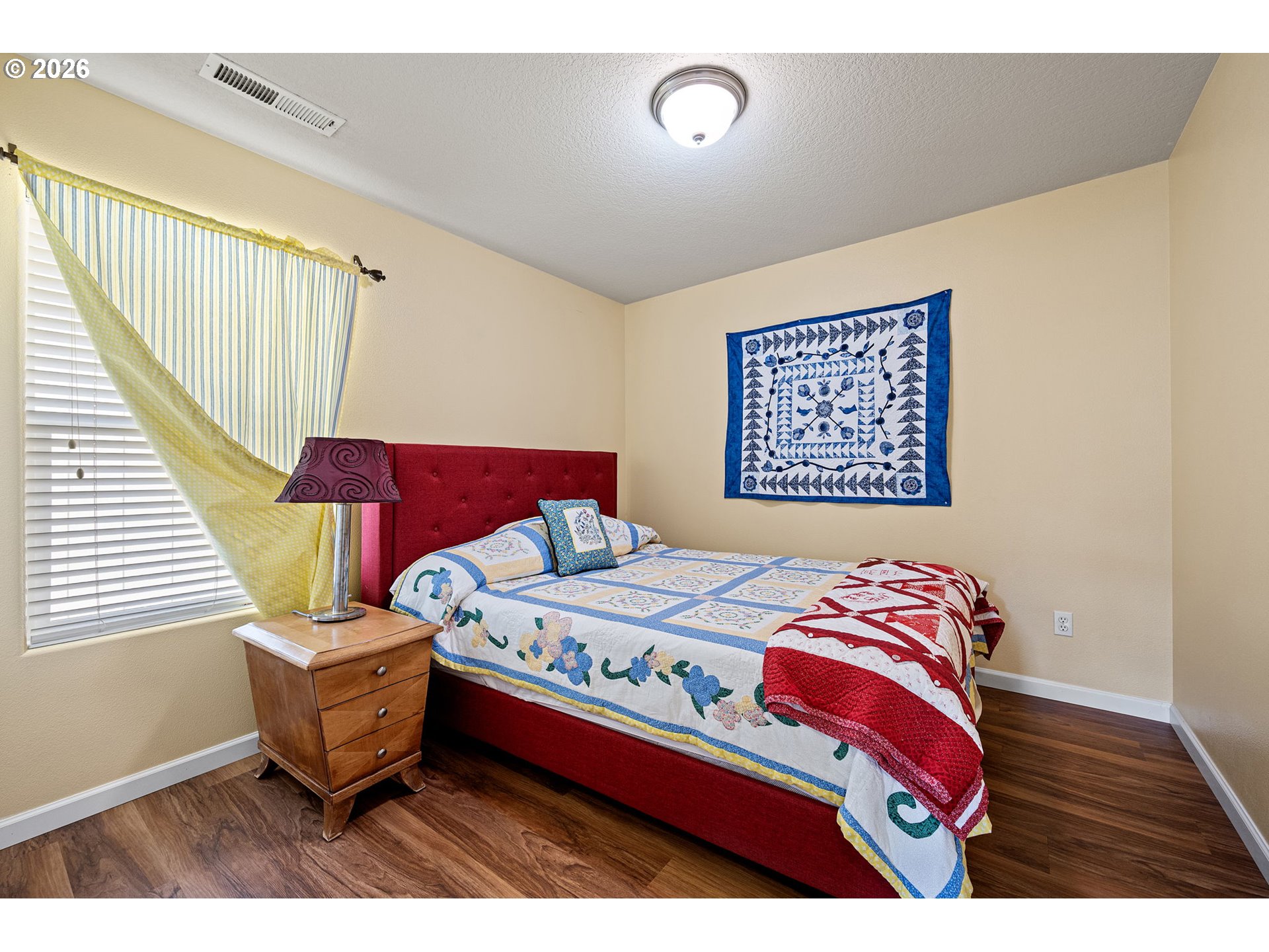 265 Southeast Casting Street Albany, OR 97322 - Photo 27 of 48 a bedroom with a bed and a painting on the wall