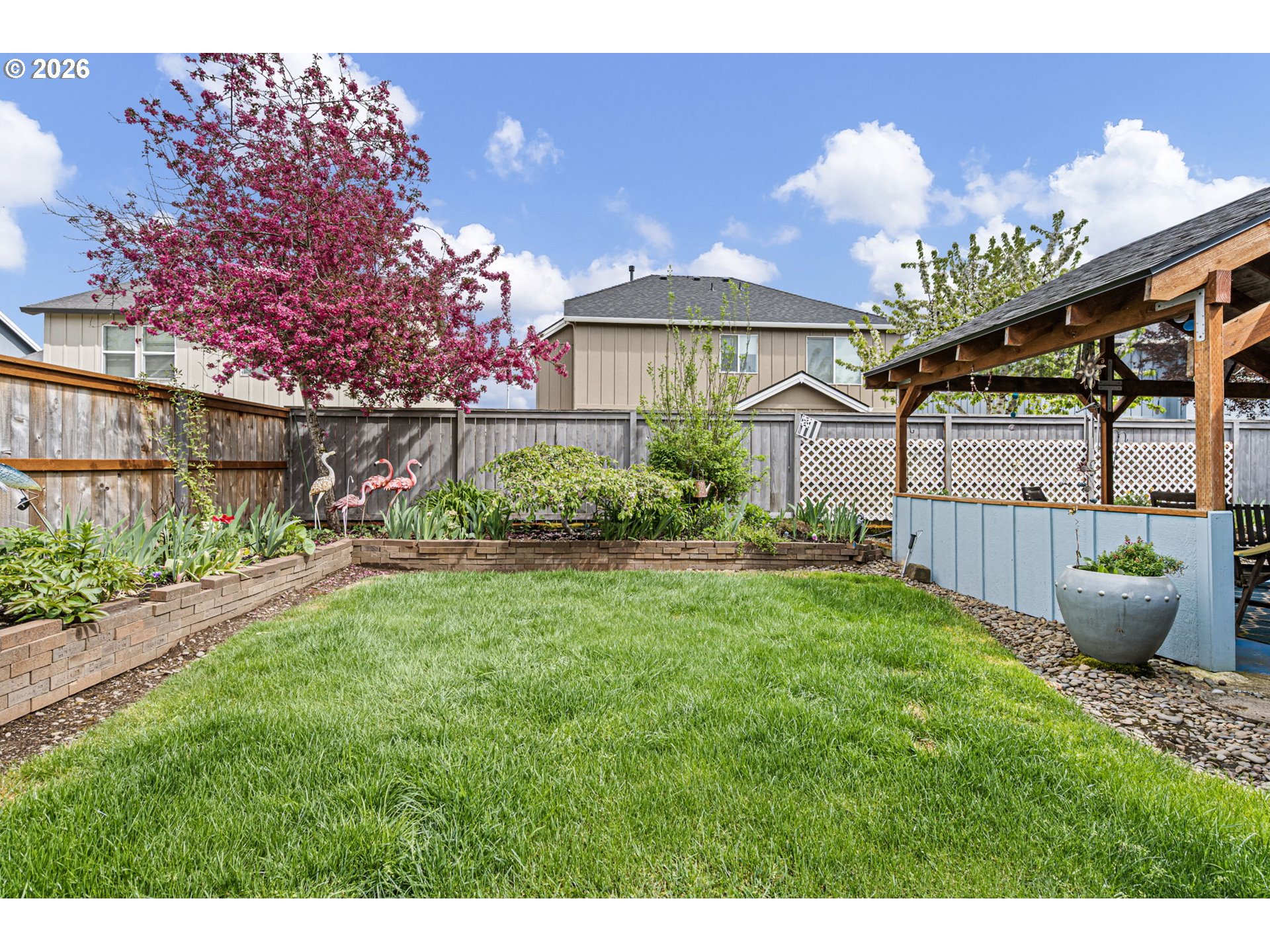 265 Southeast Casting Street Albany, OR 97322 - Photo 36 of 48 a view of a house with a yard and a garden