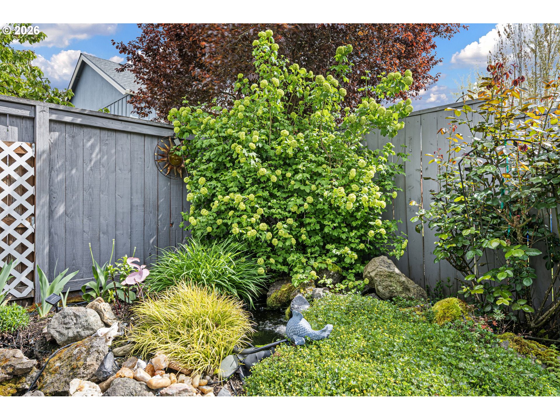 265 Southeast Casting Street Albany, OR 97322 - Photo 37 of 48 a view of a house with a flower garden