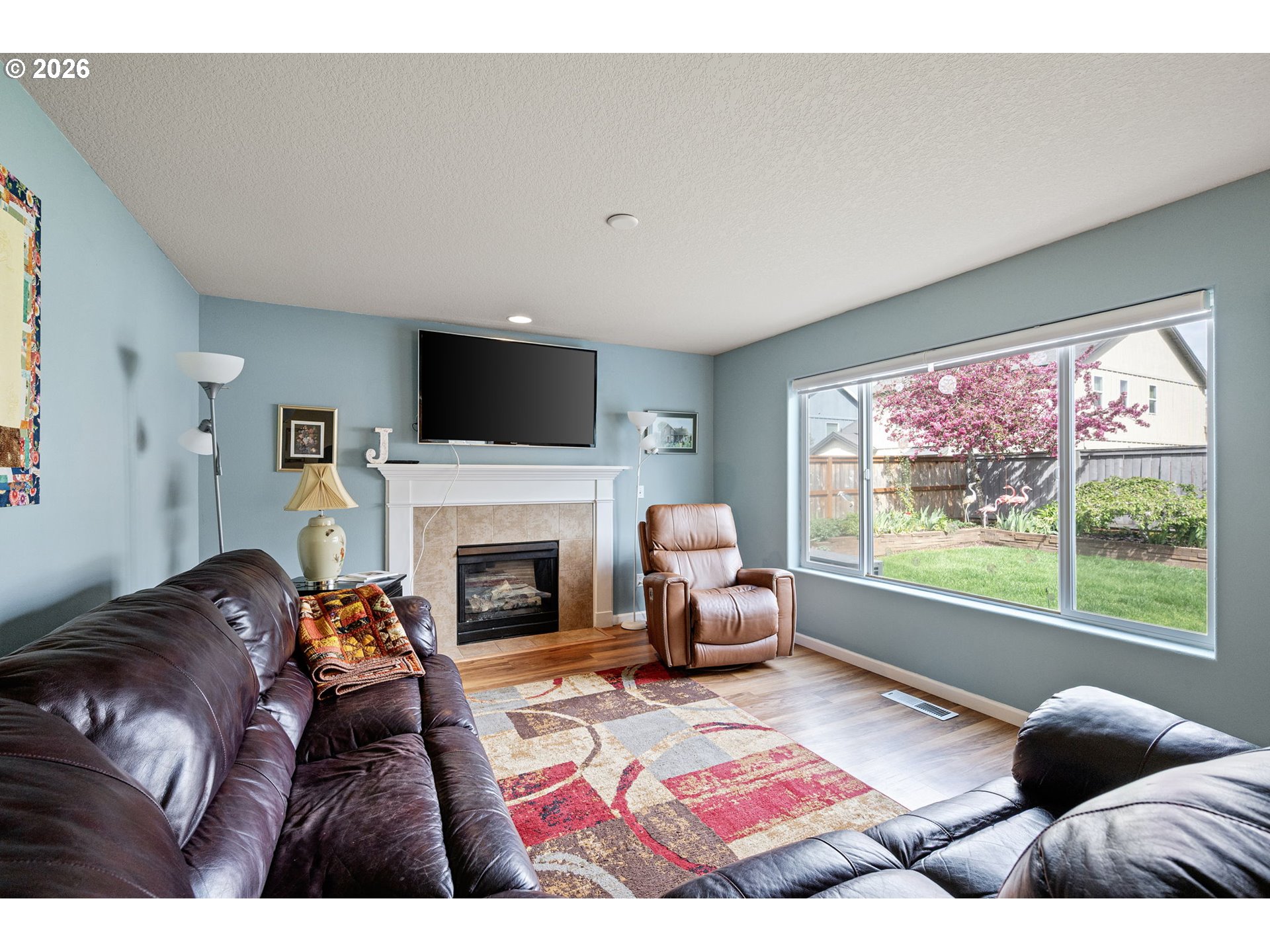265 Southeast Casting Street Albany, OR 97322 - Photo 9 of 48 a living room with furniture a fireplace and a flat screen tv