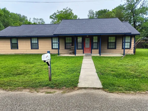 a front view of a house with a garden and porch