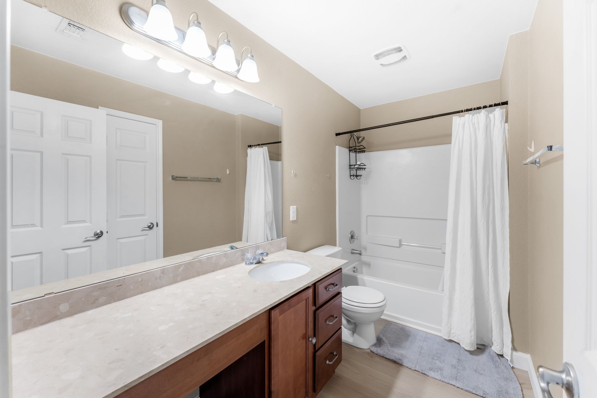 6708 Glebe Path Austin, TX 78754 - Photo 28 of 35 A bright bathroom with a spacious vanity, large mirror, and full-sized tub.