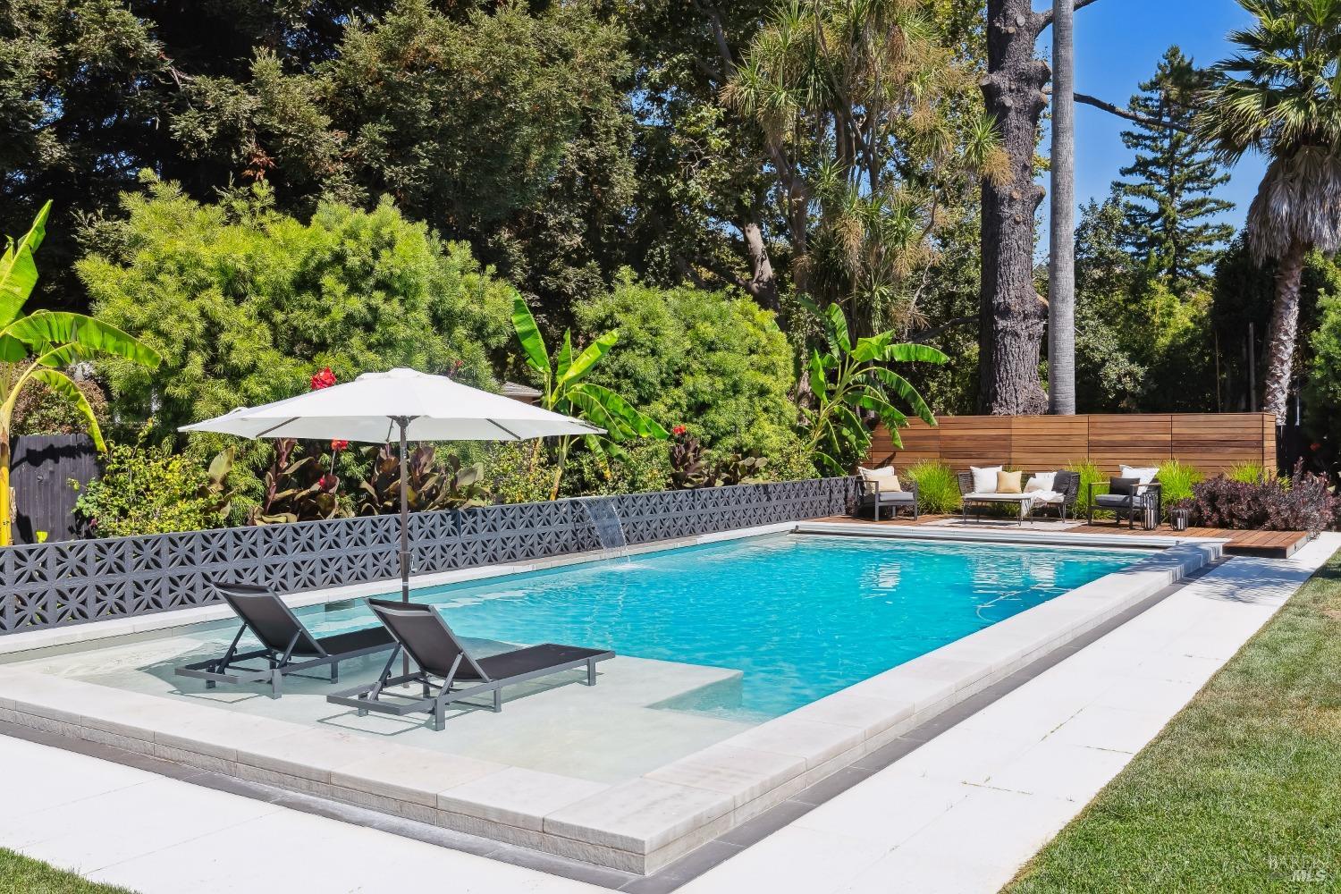 a view of a backyard with a table and chairs