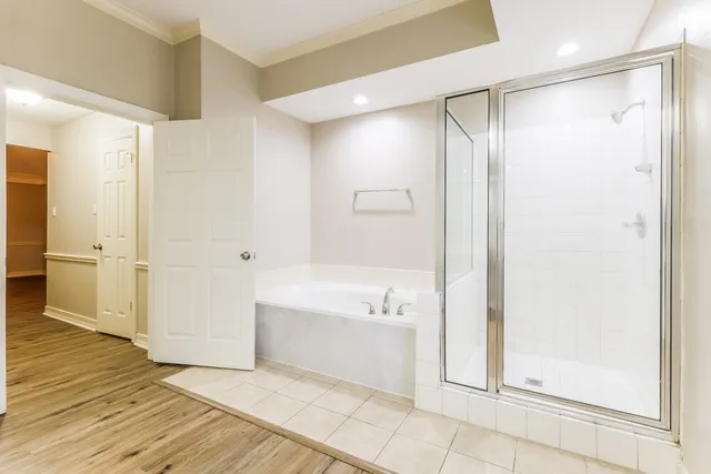 a bathroom with a bathtub and a shower