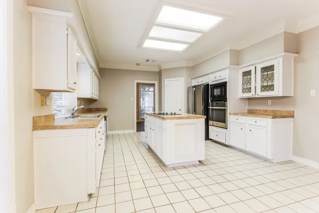 a kitchen with cabinets and white appliances